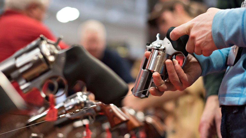 An attendee handles a revolver in the Sturm, Ruger & Co., Inc. booth on the exhibition floor of the 144th National Rifle Association (NRA) Annual Meetings and Exhibits in Nashville, Tenn. on April 11, 2015. (Photo by Daniel Acker/Bloomberg/Getty)