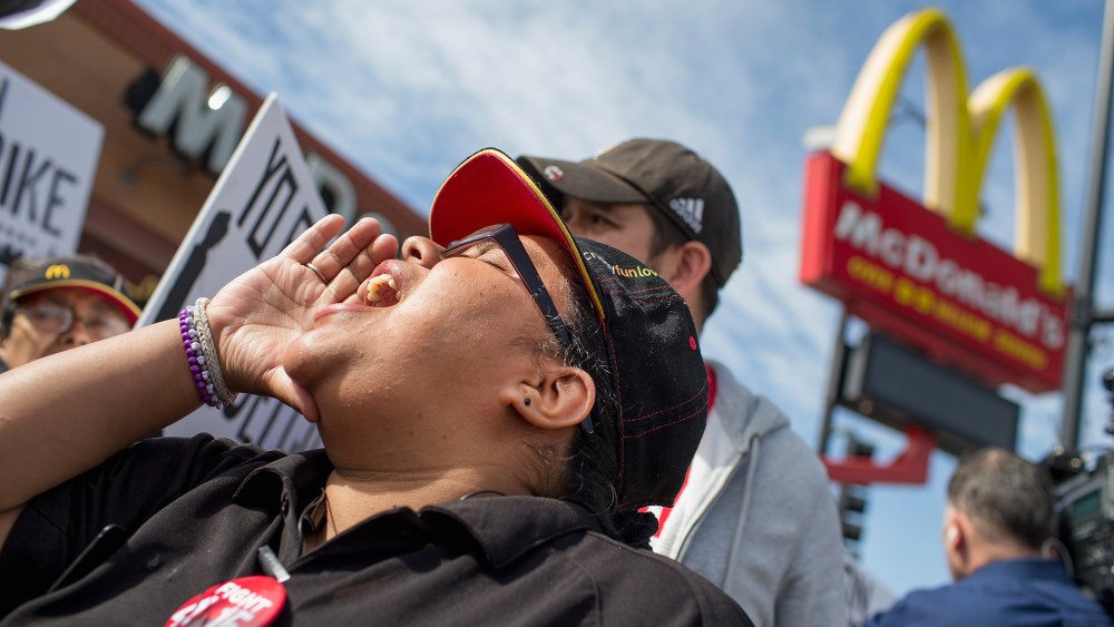 Demonstrators gather in front of a McDonald's restaurant to call for an increase in minimum wage on April 15, 2015 in Chicago, Illinois. (Photo by Scott Olson/Getty)