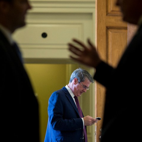 Sen. David Vitter, R-La., center, talks on his cell phone as two Senators in the foreground talk outside of the Senate Republicans' policy lunch in the Capitol on April 21, 2015 in Washington, D.C. (Photo By Bill Clark/CQ Roll Call/Getty)