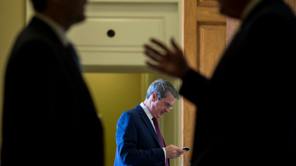 Sen. David Vitter, R-La., center, talks on his cell phone as two Senators in the foreground talk outside of the Senate Republicans' policy lunch in the Capitol on April 21, 2015 in Washington, D.C. (Photo By Bill Clark/CQ Roll Call/Getty)