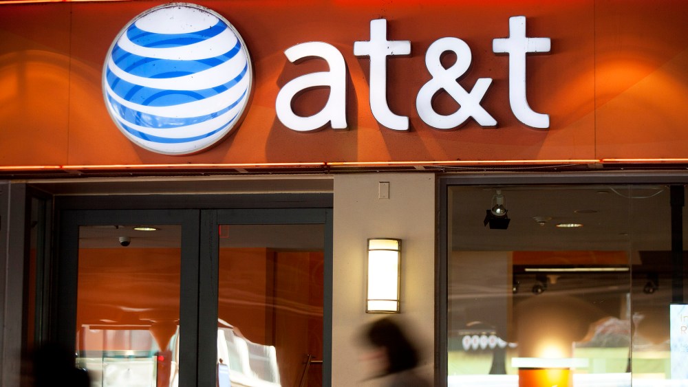 Pedestrians walk past an AT&T store in Washington, D.C. (Photo by Andrew Harrer/Bloomberg/Getty)