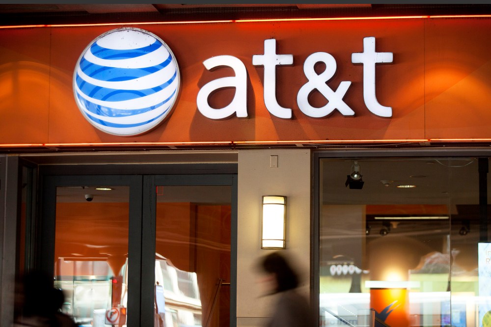 Pedestrians walk past an AT&T store in Washington, D.C. (Photo by Andrew Harrer/Bloomberg/Getty)