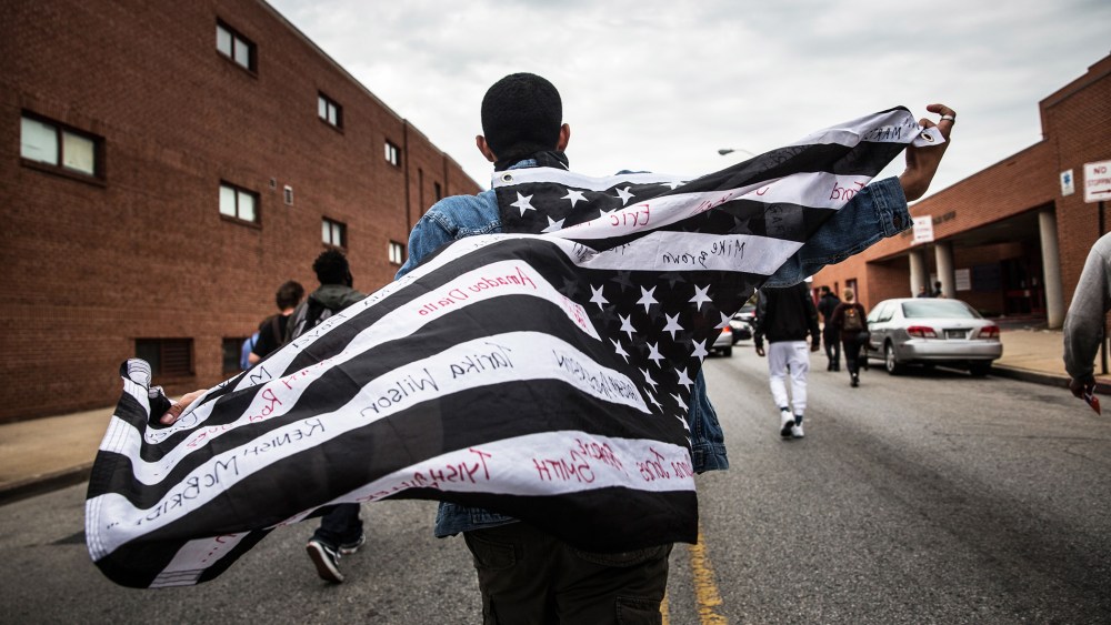 Protesters march through the streets on May 1, 2015 in Baltimore, Md., in reaction to the death of Freddie Gray. (Photo by Andrew Burton/Getty)