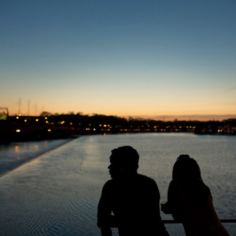 The silhouettes of people are seen watching the sunset over the Schuylkill River in Philadelphia, May 8, 2015. Philadelphia. (Photo by Victor J. Blue/Bloomberg/Getty)
