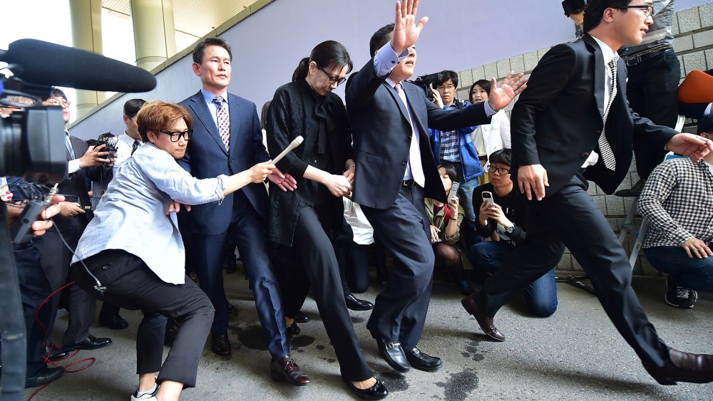 Former Korean Air (KAL) executive Cho Hyun-Ah (C) leaves after she received a suspended jail sentence and was freed by a Seoul appeals court in Seoul on May 22, 2015. (Photo by Jung Yeon-Je/AFP/Getty)