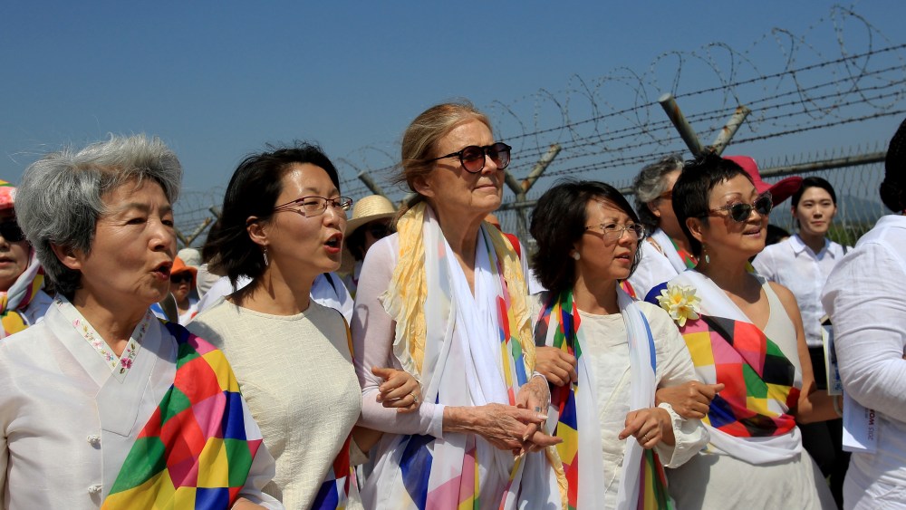 U.S. activist Gloria Steinem (C) with other activists march to the Imjingak Pavilion along the military wire fences near the border village of Panmunjom on May 24, 2015 in Paju, South Korea. (Photo by Chung Sung-Jun/Getty)