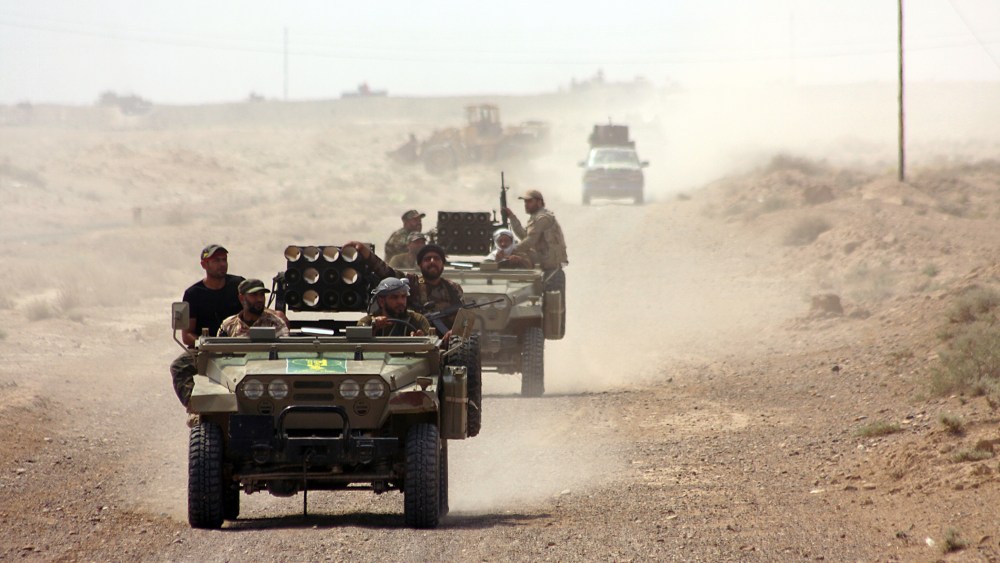 Iraqi security forces and paramilitaries deploy, on May 26, 2015, in al-Nibaie area, north-west of Baghdad, during an operation aimed at cutting off Islamic State (IS) jihadists in Anbar province. (Photo by Ahmad Al-Rubaye/AFP/Getty)