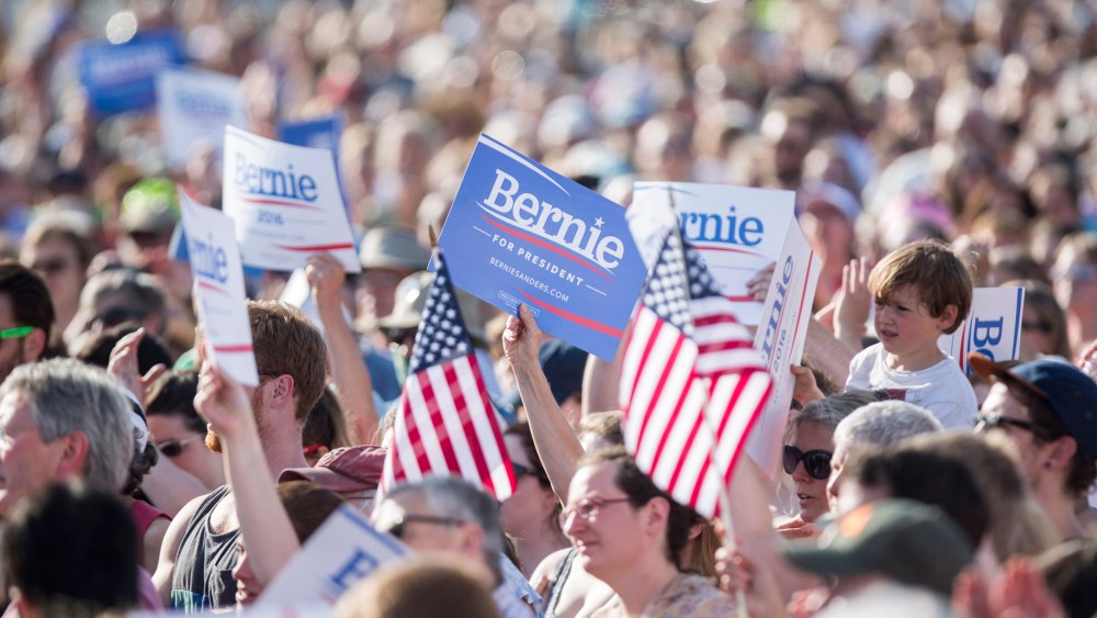 Supporters hold up signs and U.S. flags during the official kickoff to Senator Bernie Sanders' presidential campaign in Burlington, Vt. on May 26, 2015. (Photo by Scott Eisen/Bloomberg/Getty)