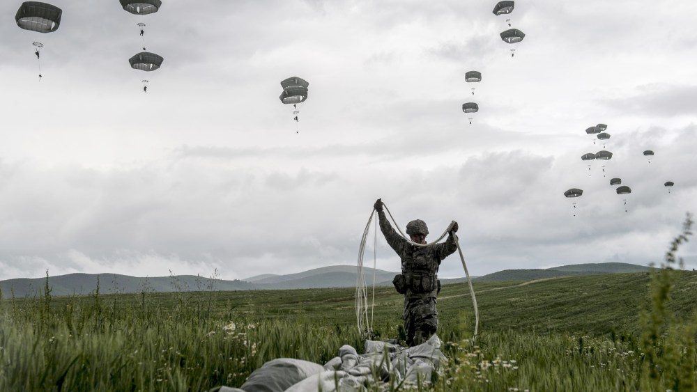 A US para-trooper of the Army's 4th 25 Infantry Brigade Combat Team, part of the NATO-led peacekeeping mission in Kosovo (KFOR) packs his parachute during a military drill near the village of Ramjan on May 27, 2015. (Photo by Armend imani/AFP/Getty)