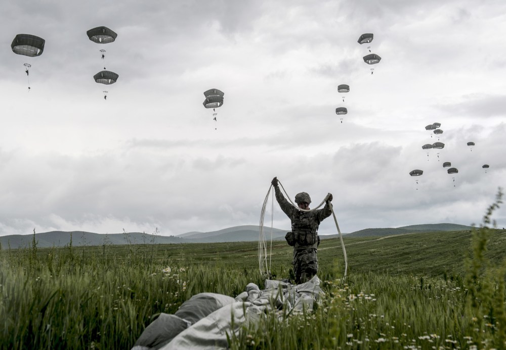 A US para-trooper of the Army's 4th 25 Infantry Brigade Combat Team, part of the NATO-led peacekeeping mission in Kosovo (KFOR) packs his parachute during a military drill near the village of Ramjan on May 27, 2015. (Photo by Armend imani/AFP/Getty)