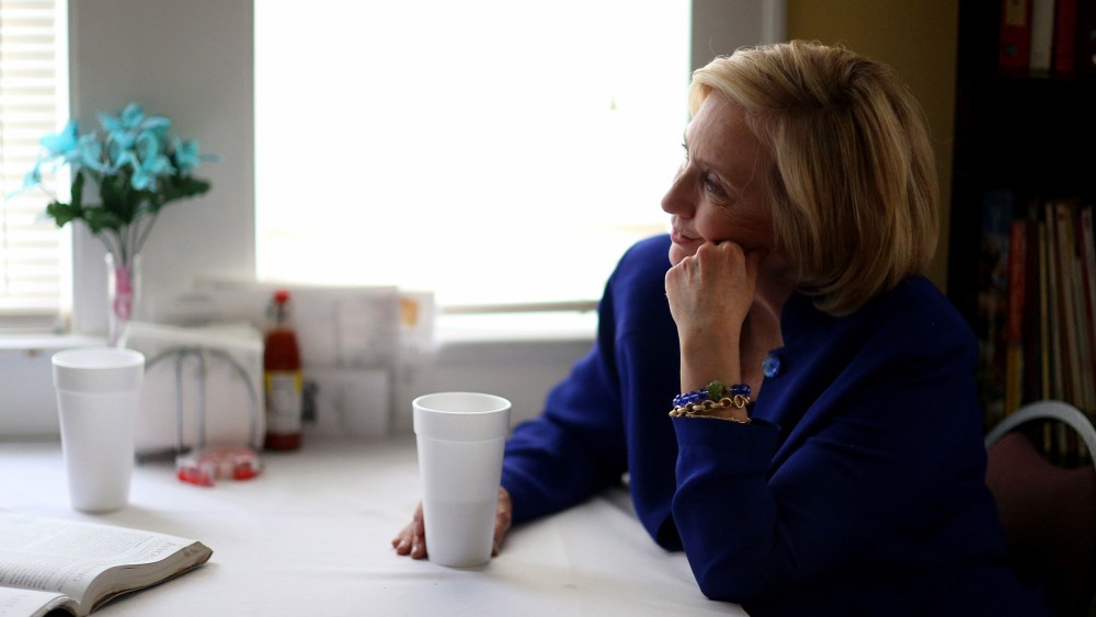 Democratic Presidential candidate Hillary Clinton sits with a customer as she visits the Main Street Bakery in Columbia, S.C. on May 27, 2015 (Photo by Joe Raedle/Getty).