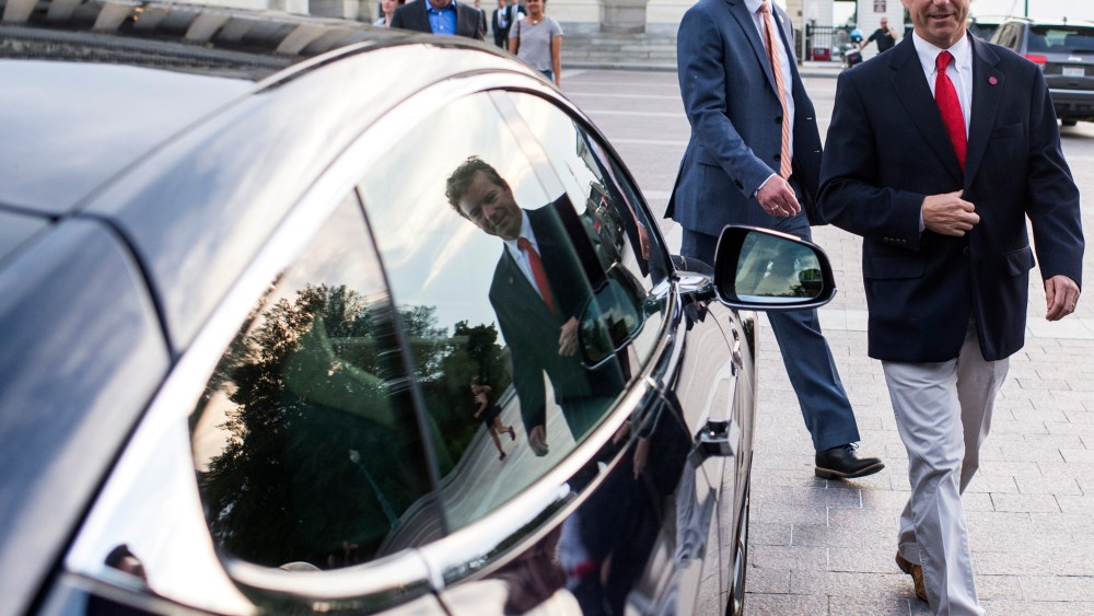 Sen. Rand Paul and Rep. Justin Amash leave the U.S. Capitol in Rep. Thomas Massie's Tesla after Sen. Paul spoke at length on the Senate floor against an extension of provisions of the Patriot Act, May 31, 2015. (Photo By Bill Clark/CQ Roll Call/Getty)