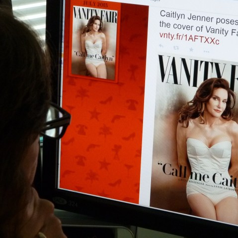 In this June 1, 2015 photo, a journalist looks at Vanity Fair's Twitter site with the Tweet about Caitlyn Jenner, who will be featured on the July cover of the magazine. (Photo by Mladen Antonov/AFP/Getty)