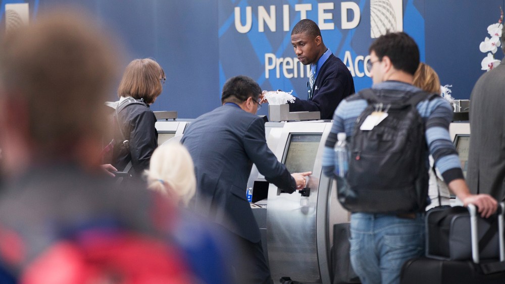 Passengers check-in for flights with United Airlines. (Photo by Scott Olson/Getty)