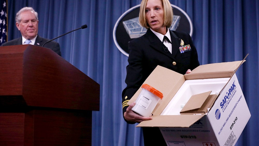 Director of Medical Programs for DoD Chemical and Biological Defense Cdr. Franca Jones demonstrate protocol for shipping anthrax samples during a news briefing on the Anthrax shipment investigation, June 3, 2015 at the Pentagon. (Photo by Alex Wong/Getty)