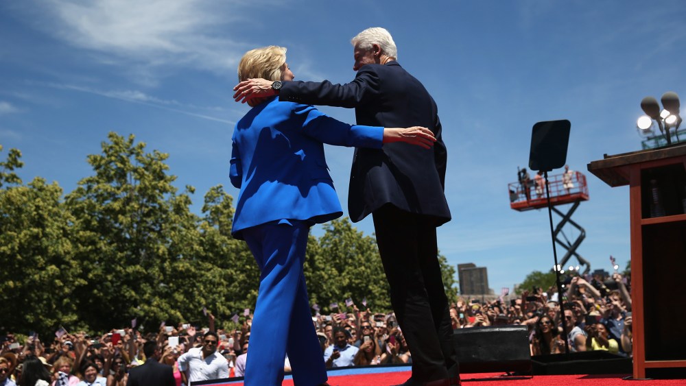 Democratic Presidential candidate Hillary Clinton and former President Bill Clinton embrace after Hillary officially launched her presidential campaign at a rally on June 13, 2015 in New York City. (Photo by John Moore/Getty)