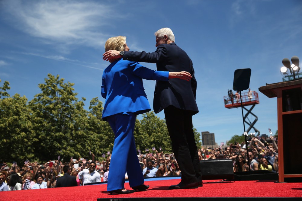 Democratic Presidential candidate Hillary Clinton and former President Bill Clinton embrace after Hillary officially launched her presidential campaign at a rally on June 13, 2015 in New York City. (Photo by John Moore/Getty)