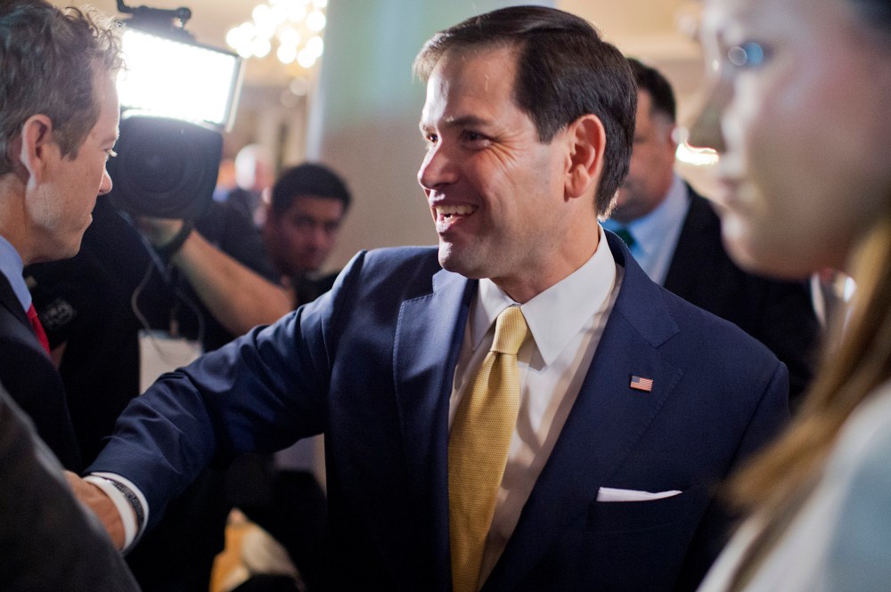 Sen. Marco Rubio walks past Sen. Rand Paul during the Faith & Freedom Coalitions Road to Majority conference which featured speeches by conservative politicians at the Omni Shoreham Hotel, June 18, 2015. (Photo By Tom Williams/CQ Roll Call/Getty)