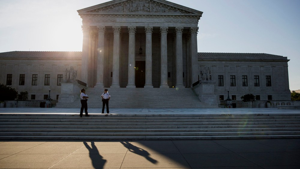 Police officers stand in front of the U.S. Supreme Court in Washington, D.C., June 22, 2015. (Photo by Drew Angerer/Bloomberg/Getty)