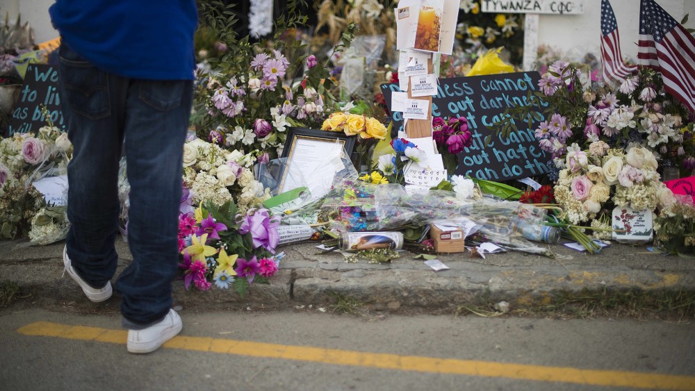 A boy pauses next to thousands of flowers and cards outside Emanuel AME Church in Charleston, South Carolina, on June 23, 2015. (Photo by Jim Watson/AFP/Getty)