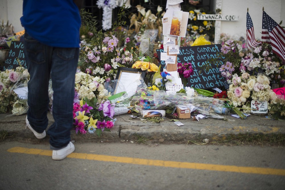 A boy pauses next to thousands of flowers and cards outside Emanuel AME Church in Charleston, South Carolina, on June 23, 2015. (Photo by Jim Watson/AFP/Getty)