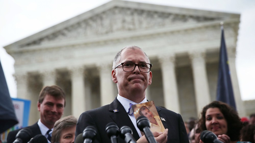 Plaintiff Jim Obergefell holds a photo of his late husband John Arthur as he speaks to the media after the U.S. Supreme Court ruled in favor of same-sex marriage, June 26, 2015, in Washington, DC. (Photo by Alex Wong/Getty)