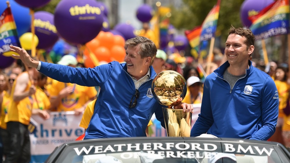 Golden State Warriors President and COO Rick Welts waves to the crowd while holding the NBA championship trophy during the annual Gay Pride Parade in San Francisco, Calif., June 28, 201. (Photo by Josh Edelson/AFP/Getty)
