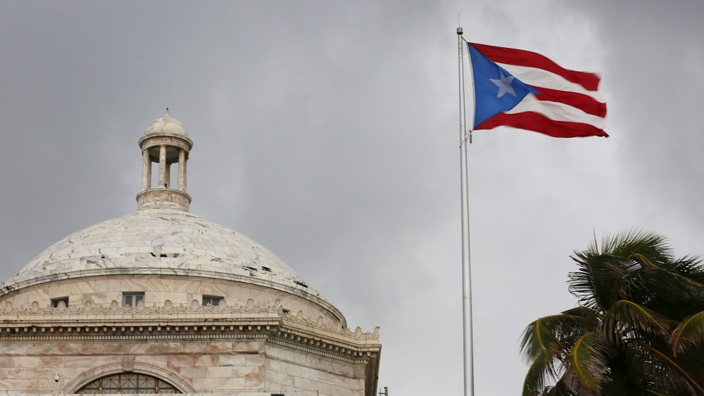 The Puerto Rican flag flies near the Capitol building as the island's residents deal with the government's $72 billion debt on July 1, 2015 in San Juan, Puerto Rico. (Photo by Joe Raedle/Getty)