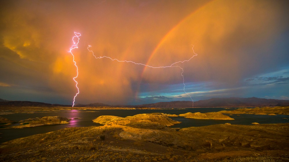 Lightning strikes near a rainbow over Lake Mead National Recreation Area in Lake Mead, Nev. on Jul. 1, 2015 (Photo by Allen J. Schaben/Los Angeles Times/Getty).