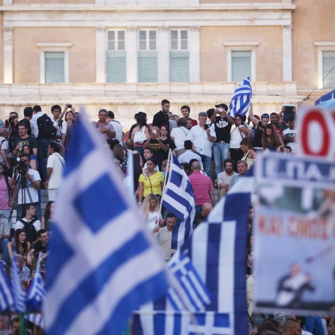 People celebrate in front of the Greek parliament as early opinion polls predict a win for the Oxi, or No, campaign in the Greek austerity referendum on July 5, 2015 in Athens, Greece. (Photo by Christopher Furlong/Getty)