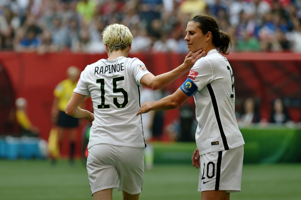 Carli Lloyd greets exiting teammate Megan Rapinoe during the FIFA Women's World Cup Final against Japan, which they won, at BC Place Stadium on July 5, 2015 in Vancouver, Canada. (Photo by Rich Lam/Getty)