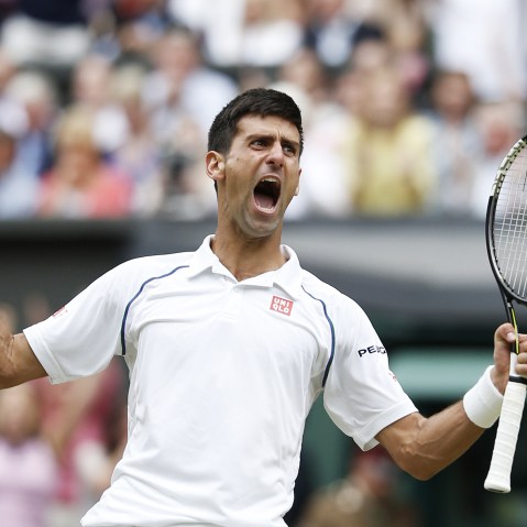 Serbia's Novak Djokovic celebrates beating Switzerland's Roger Federer during their men's singles final match on Centre Court at the 2015 Wimbledon Championships in Wimbledon, southwest London, on July 12, 2015.(Photo by Adrian Dennis/AFP/Getty)