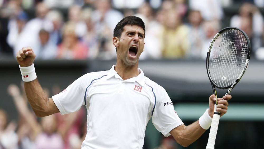 Serbia's Novak Djokovic celebrates beating Switzerland's Roger Federer during their men's singles final match on Centre Court at the 2015 Wimbledon Championships in Wimbledon, southwest London, on July 12, 2015.(Photo by Adrian Dennis/AFP/Getty)