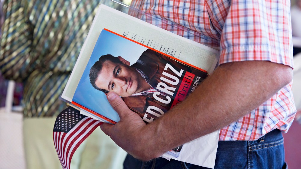A guest holds a book by Senator Ted Cruz during The Family Leadership Summit in Ames, Iowa on July 18, 2015. (Photo by Daniel Acker/Bloomberg/Getty)
