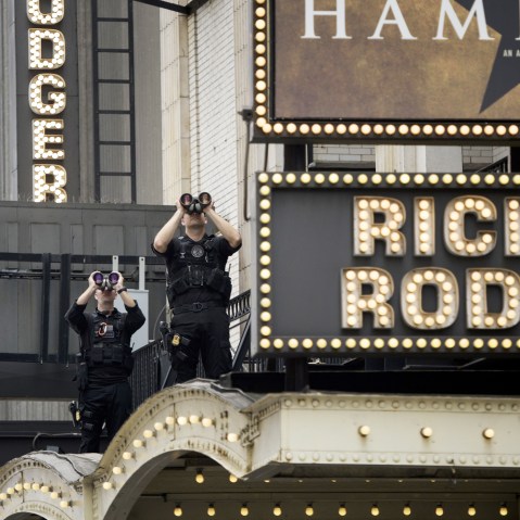 Members of the Secret Service watch over the Richard Rodgers Theatre while US President Barack Obama attends a showing of "Hamilton" with his daughters Sasha and Malia Obama on July 18, 2015 in N.Y. (Photo by Brendan Smialowski/AFP/Getty)