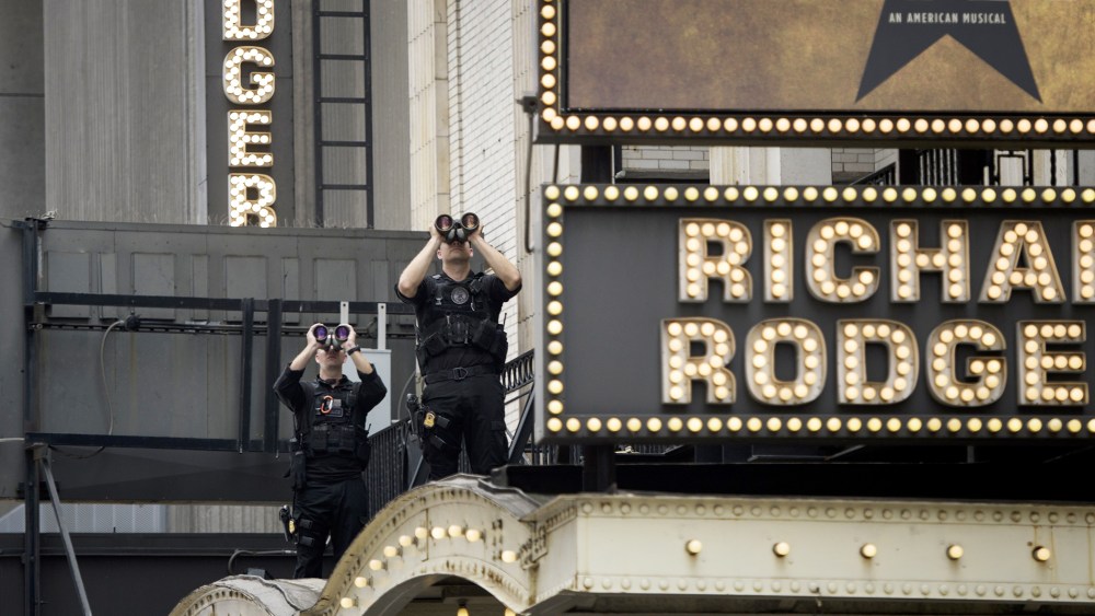 Members of the Secret Service watch over the Richard Rodgers Theatre while US President Barack Obama attends a showing of "Hamilton" with his daughters Sasha and Malia Obama on July 18, 2015 in N.Y. (Photo by Brendan Smialowski/AFP/Getty)