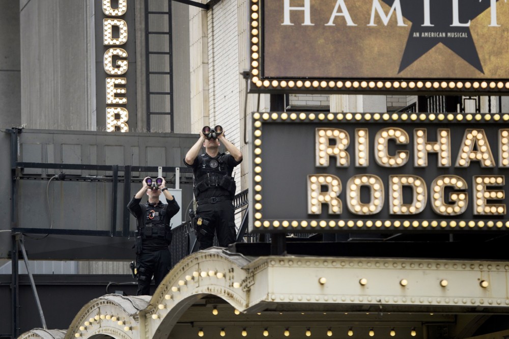Members of the Secret Service watch over the Richard Rodgers Theatre while US President Barack Obama attends a showing of "Hamilton" with his daughters Sasha and Malia Obama on July 18, 2015 in N.Y. (Photo by Brendan Smialowski/AFP/Getty)