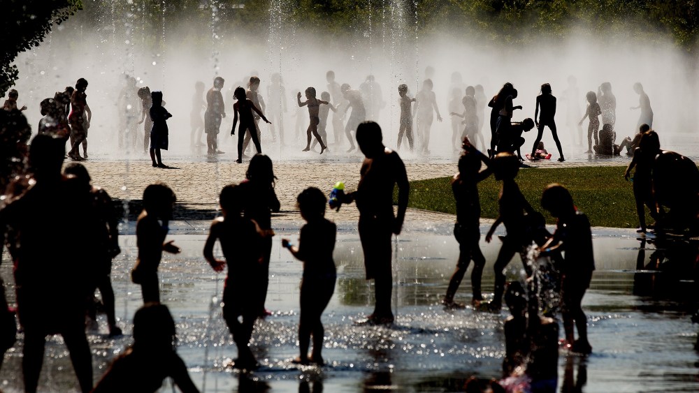 Children cool off as they play under a fountain next to the Manzanares river on July 21, 2015 in Madrid, Spain. (Photo by Pablo Blazquez Dominguez/Getty)