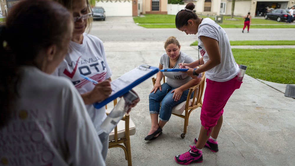 Soraya Marquez, state coordinator for Mi Familia Vota, and her crew hit a Puerto Rican neighborhood, registering Latinos to vote in the 2016 presidential election on July 24, 2015 in Kissimmee, Fl. (Photo by Charles Ommanney/The Washington Post/Getty)