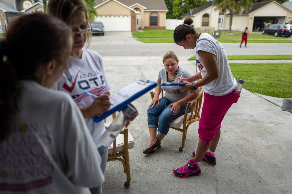 Soraya Marquez, state coordinator for Mi Familia Vota, and her crew hit a Puerto Rican neighborhood, registering Latinos to vote in the 2016 presidential election on July 24, 2015 in Kissimmee, Fl. (Photo by Charles Ommanney/The Washington Post/Getty)