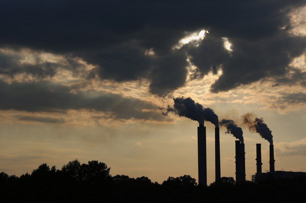 The silhouettes of emissions are seen rising from stacks of the Duke Energy Corp. Gibson Station power plant at dusk in Indiana, July 23, 2015. (Photo by Luke Sharrett/Bloomberg/Getty)