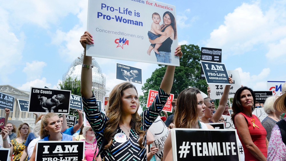 Anti-abortion activists hold a rally opposing federal funding for Planned Parenthood (Photo by Olivier Douliery/Getty).