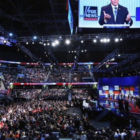 Republican presidential candidate Wisconsin Gov. Scott Walker appears on the screen hanging above the debate at the Quicken Loans Arena August 6, 2015 in Cleveland, Ohio. (Photo by Chip Somodevilla/Getty)