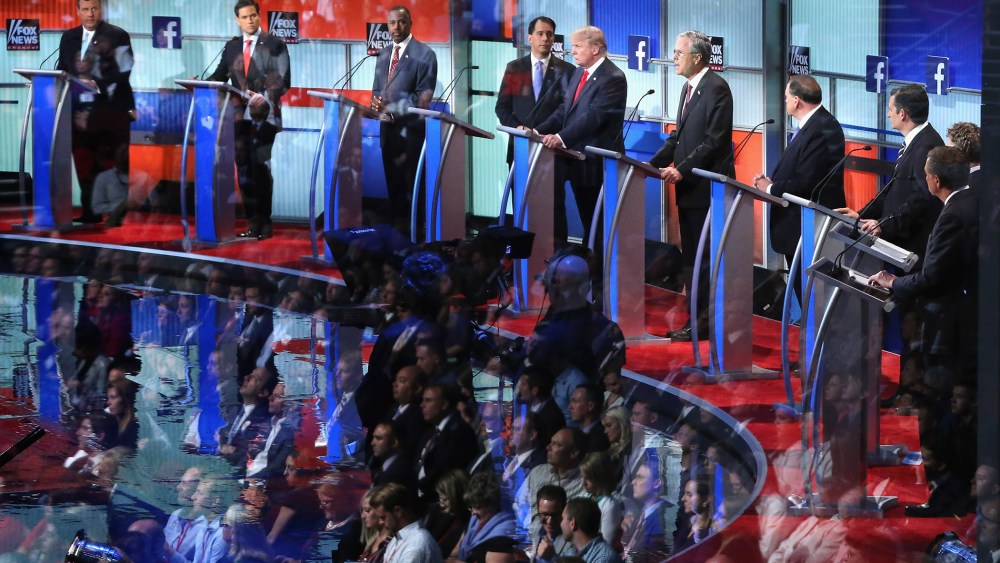 Audience members are reflected in a window as Republican presidential candidates participate in the presidential debate hosted by FOX News and Facebook at the Quicken Loans Arena on Aug. 6, 2015 in Cleveland, Ohio. (Photo by Chip Somodevilla/Getty)