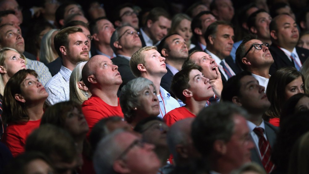 Audience members look up at the large video screen hanging above the first prime-time Republican presidential debate hosted by FOX News and Facebook at the Quicken Loans Arena on Aug. 6, 2015 in Cleveland, Ohio. (Photo by Chip Somodevilla/Getty)