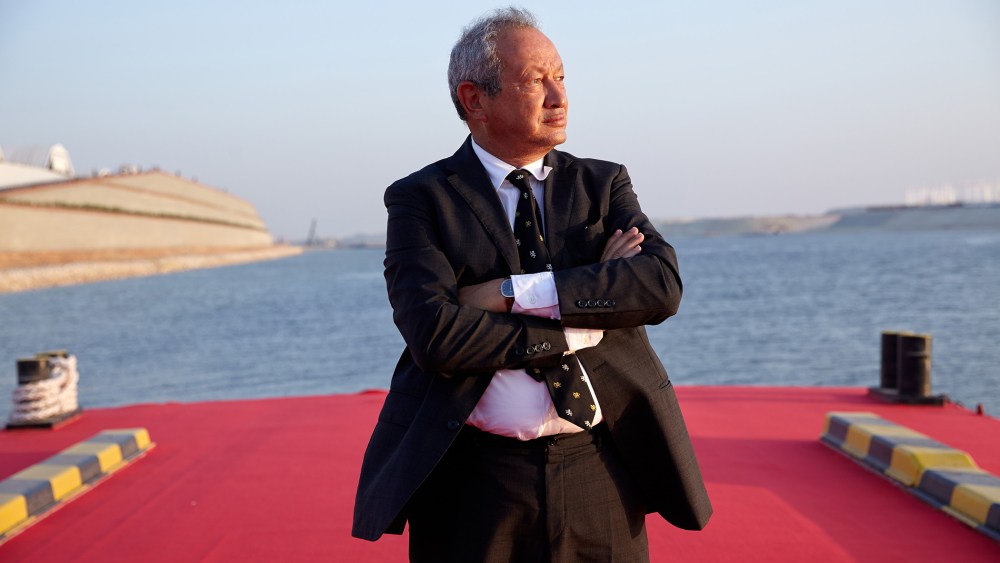 Egyptian billionaire Naguib Sawiris poses for a photograph on a floating pontoon in front of the New Suez Canal, operated by the Suez Canal Authority, in Ismailia, Egypt, Aug. 6, 2015. (Photo by Shawn Baldwin/Bloomberg/Getty)