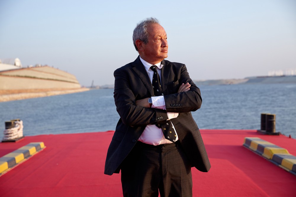 Egyptian billionaire Naguib Sawiris poses for a photograph on a floating pontoon in front of the New Suez Canal, operated by the Suez Canal Authority, in Ismailia, Egypt, Aug. 6, 2015. (Photo by Shawn Baldwin/Bloomberg/Getty)