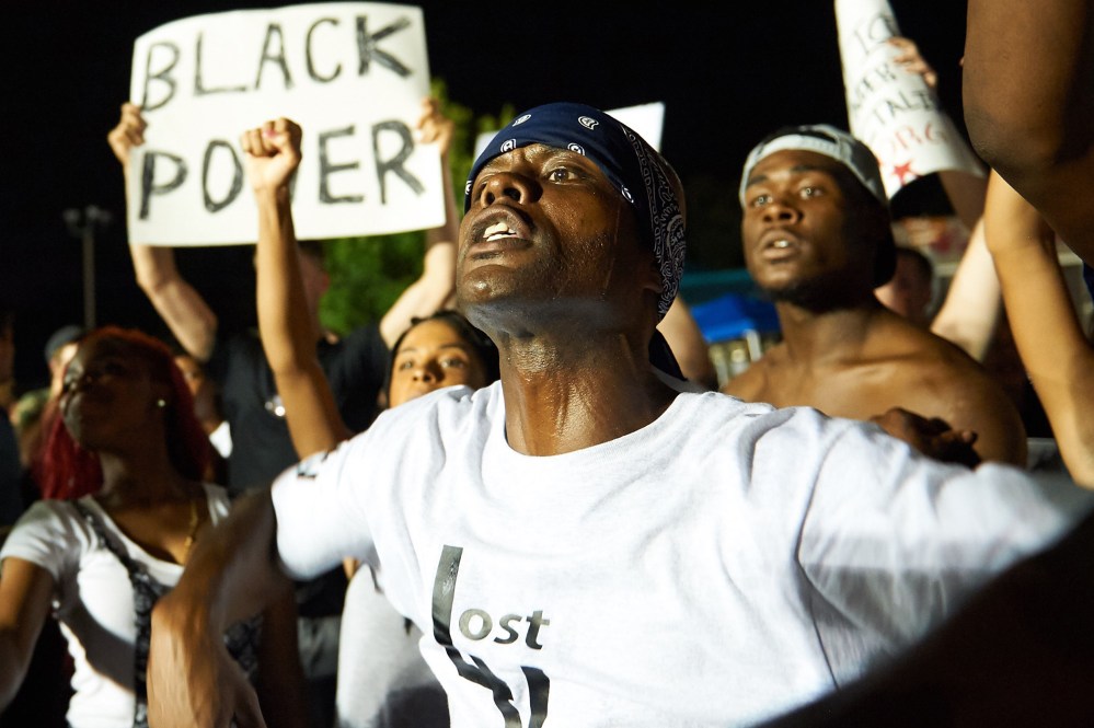 Demonstrators protest during a march on Aug. 8, 2015 at the Ferguson Police Department in Ferguson, Mo. (Photo by Michael B. Thomas/AFP/Getty)