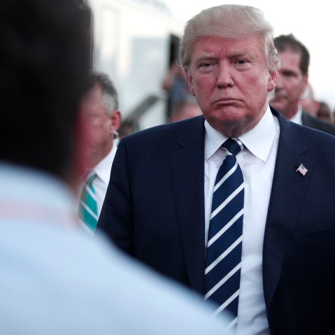 Republican presidential candidate Donald Trump speaks with the media on his way to his car after delivering the keynote address at the Genesee and Saginaw Republican Party Lincoln Day Event, Aug. 11, 2015 in Birch Run, Mich. (Photo by Bill Pugliano/Getty)