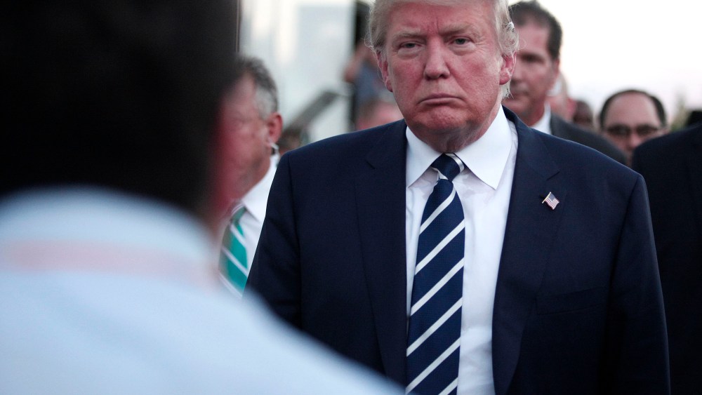 Republican presidential candidate Donald Trump speaks with the media on his way to his car after delivering the keynote address at the Genesee and Saginaw Republican Party Lincoln Day Event, Aug. 11, 2015 in Birch Run, Mich. (Photo by Bill Pugliano/Getty)